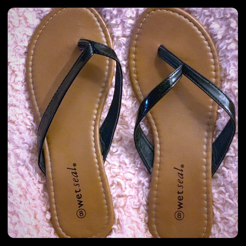 Tan flip flops with black straps
